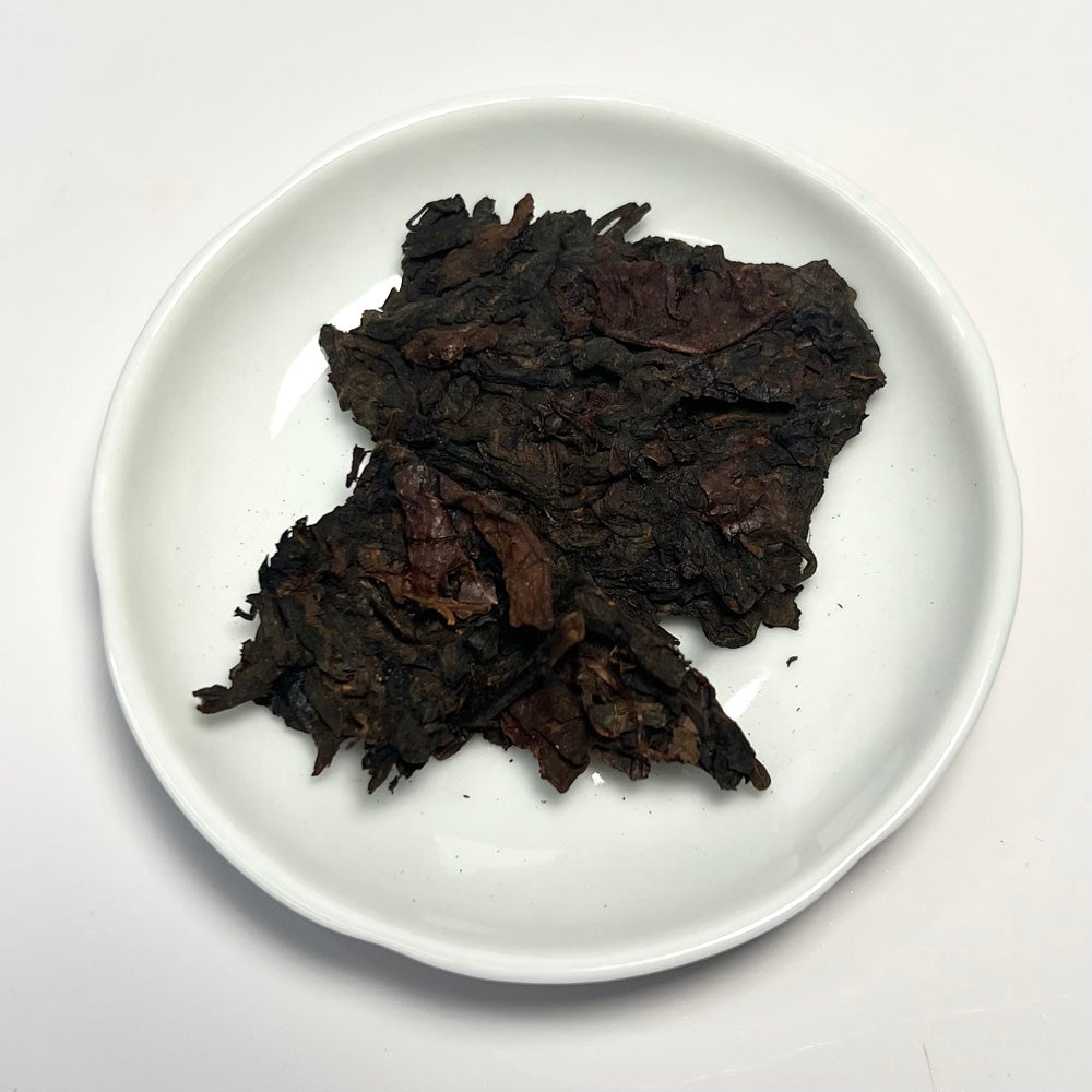 Dark brown dried leaves on a white plate
