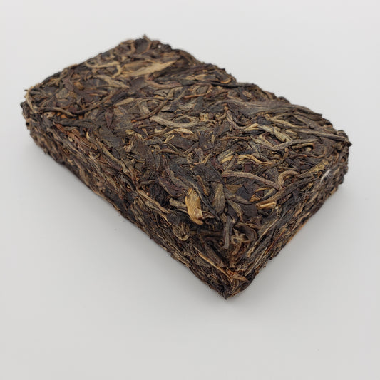 Pressed Pu-erh tea brick on a white background