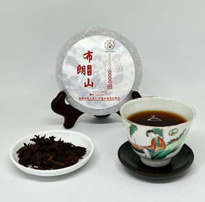 Tea packaging with a cup and saucer on a light gray background