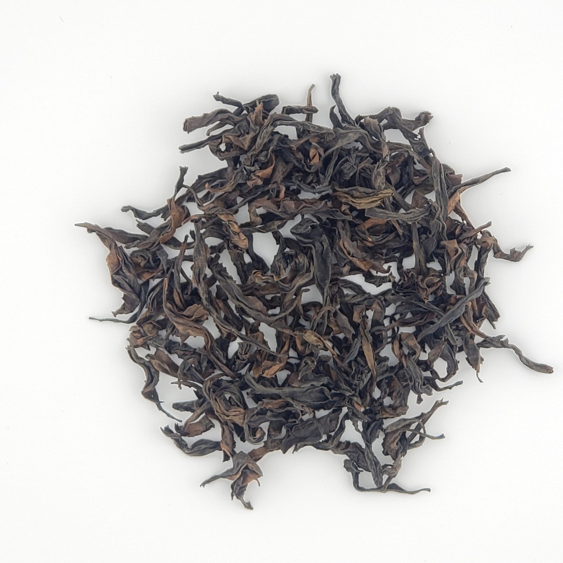 Close up of tea leaves on a white background