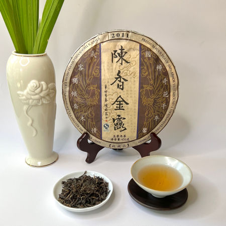 Tea packaging with a bowl of tea leaves and a cup of tea on a white background