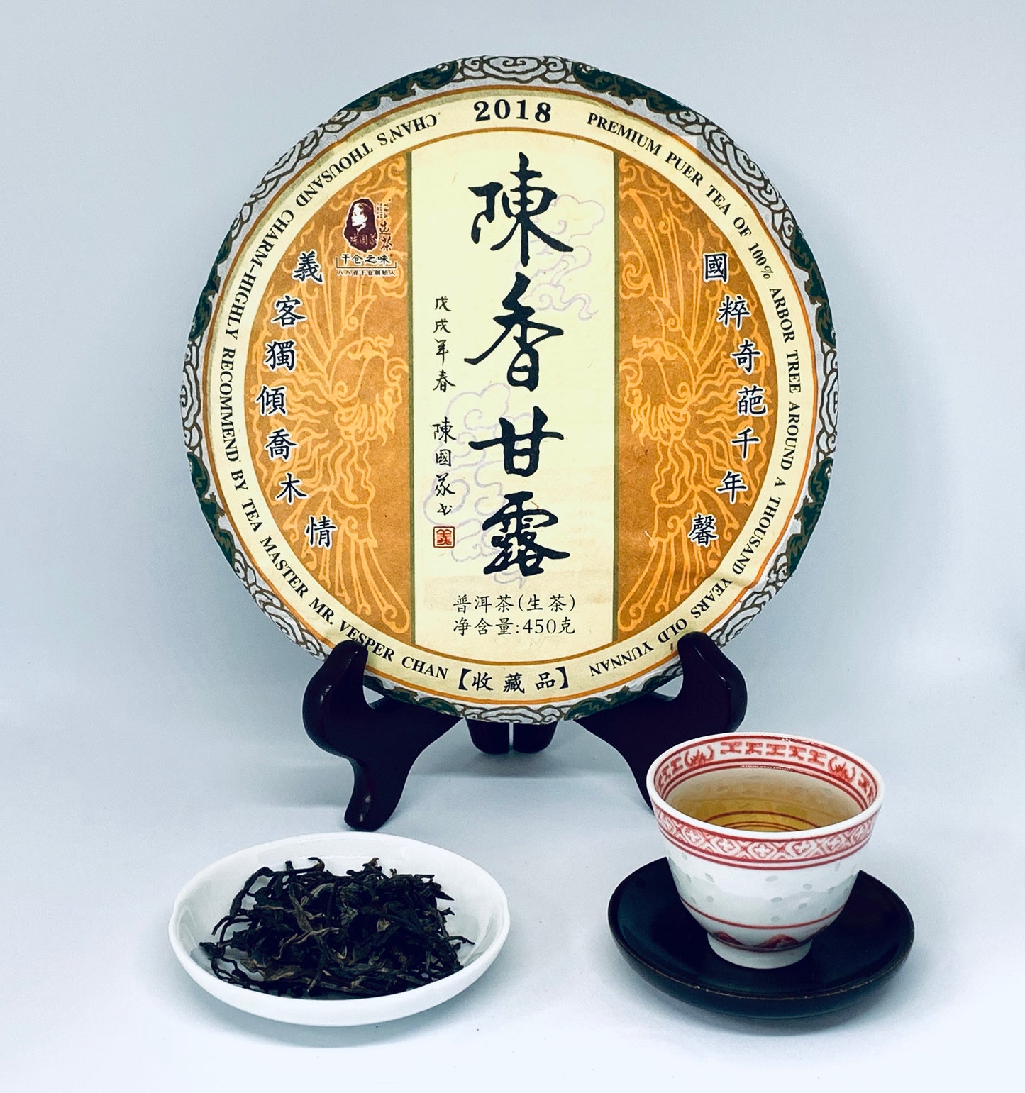 Tea cake with a cup of tea and loose tea leaves on a white background