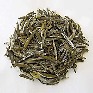Green tea leaves on a white background