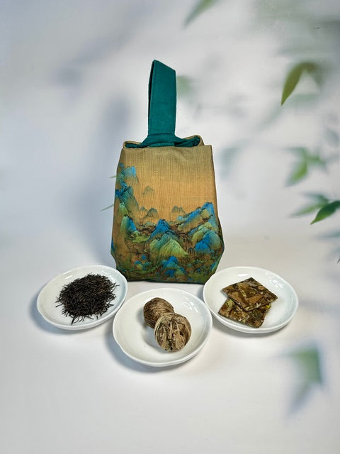Tea leaves and tea bricks on white plates with a decorative tea pouch in the background.