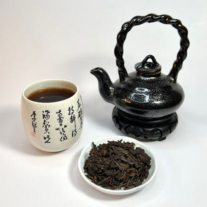 Tea set with a teapot, cup, and bowl of tea leaves on a white background