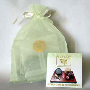 Green organza bag filled with tea samples and a Bana brochure