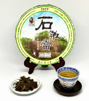 Tea packaging with a cup of tea and loose tea leaves on a white background