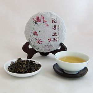 Tea packaging with a tea leaf dish and cup of tea on a white background