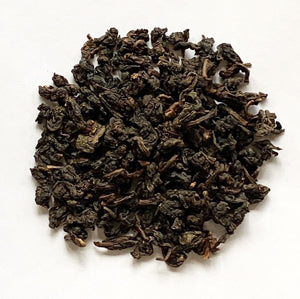 Dry tea leaves on a white background