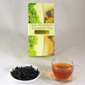 Tea package from Bana Tea Company with a cup of tea and a bowl of tea leaves on a white background