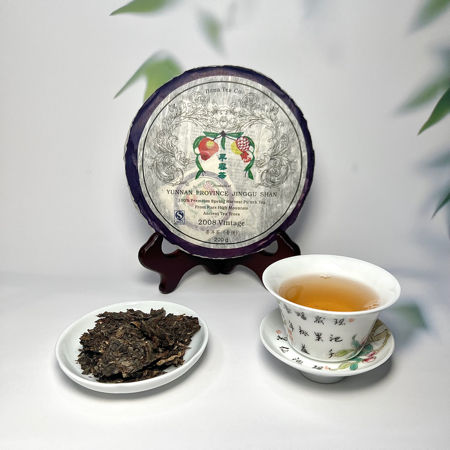 Tea packaging, tea leaves, and a teacup with tea on a white background