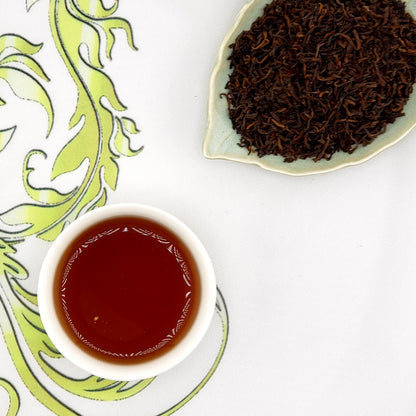 ripe pu-erh tea leaves and a cup of brewed tea