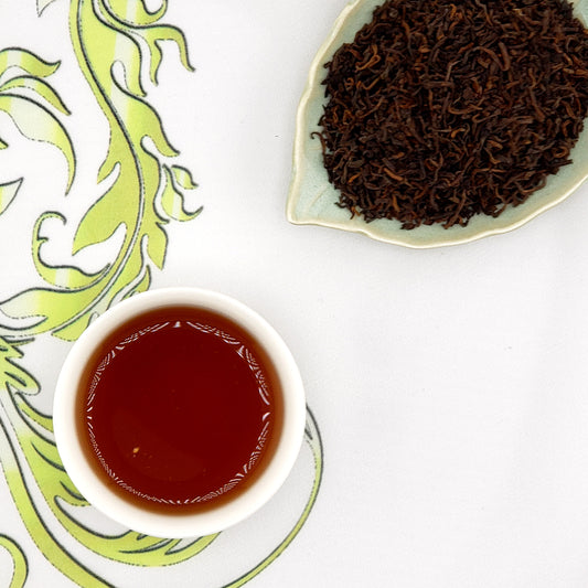 ripe pu-erh tea leaves and a cup of brewed tea