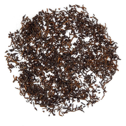 ripe pu-erh tea leaves, close up, on white surface