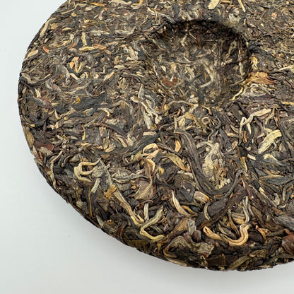 Close-up of a Pu-erh tea cake on a white background