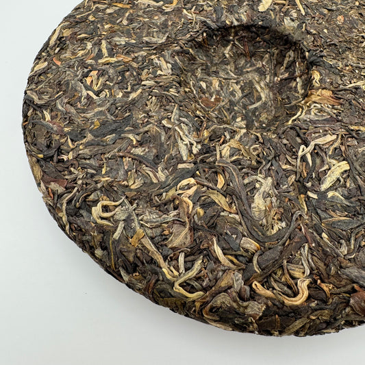 Close-up of a Pu-erh tea cake on a white background