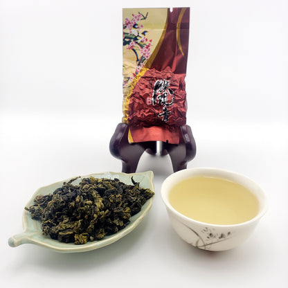 Tea packaging with a cup of tea and a bowl of loose tea leaves on a white background
