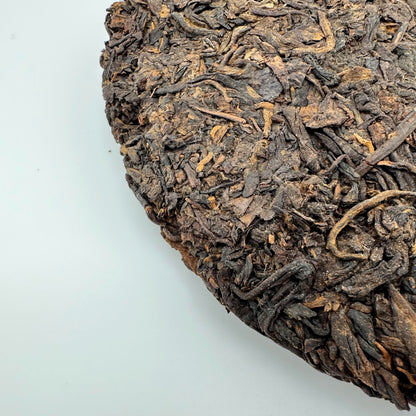 Close up of the back of a pressed cake of pu-erh tea.
