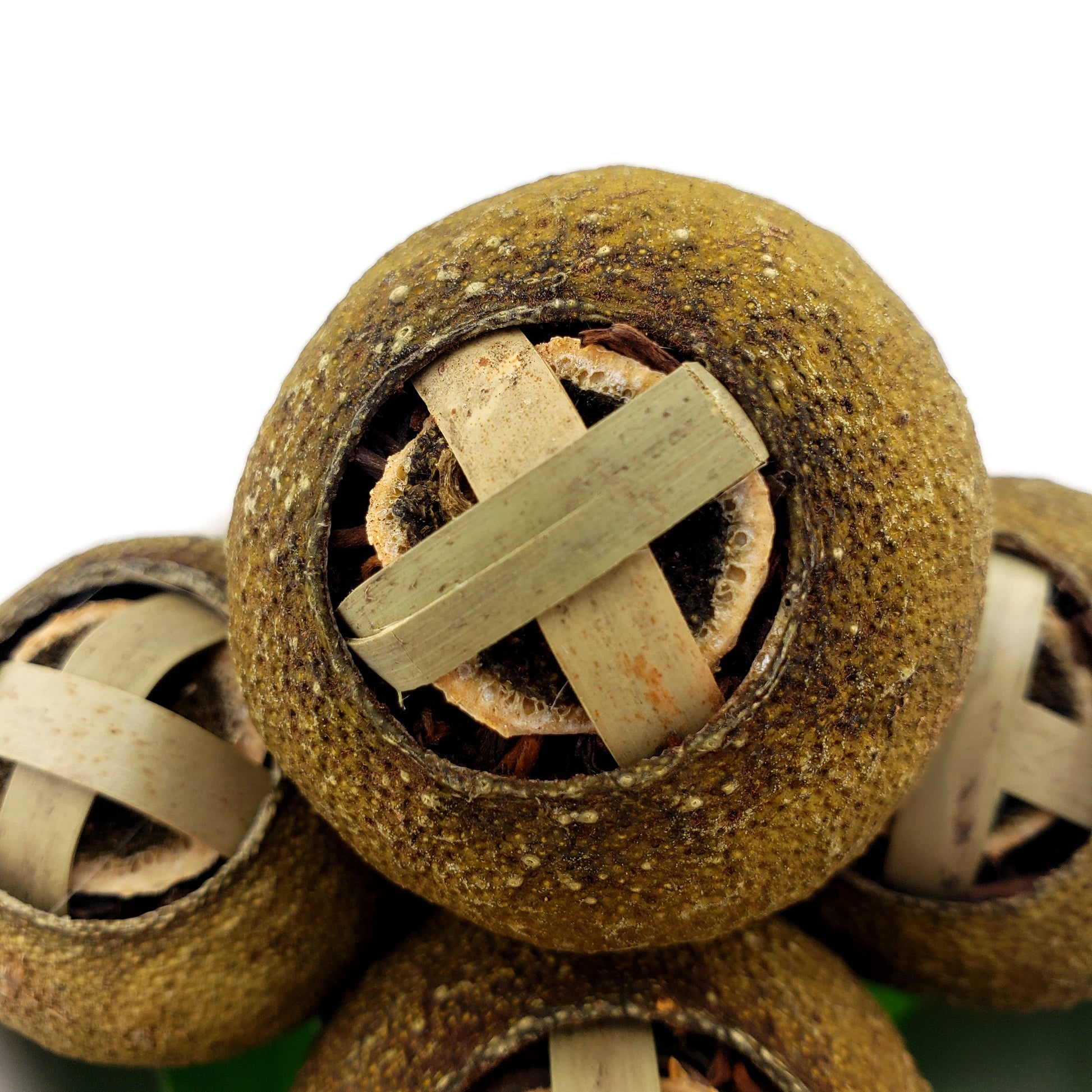 Close-up of a green mandarin closed with a bamboo clasp