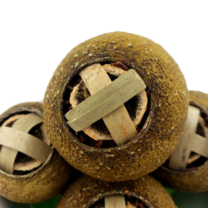 Close-up of a green mandarin closed with a bamboo clasp