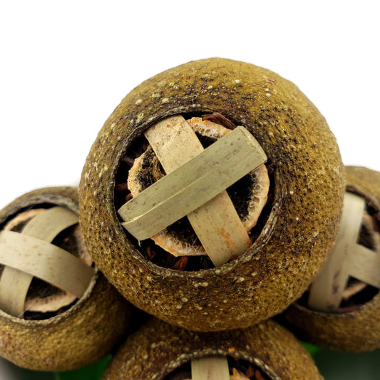 Close-up of a green mandarin closed with a bamboo clasp