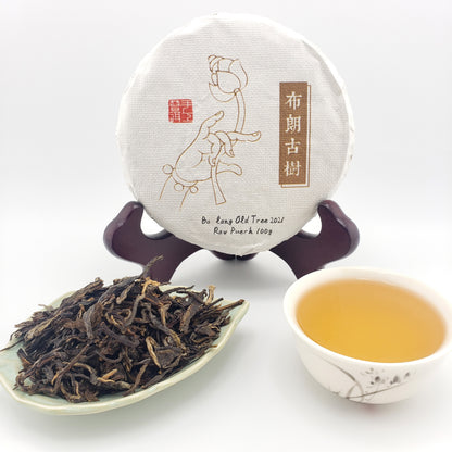 Tea packaging, tea leaves, and a cup of tea on a white background