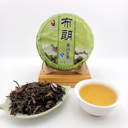 Tea cake, tea leaves, and a cup of tea on a white background