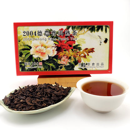 Tea packaging with tea leaves and a cup of tea on a white background