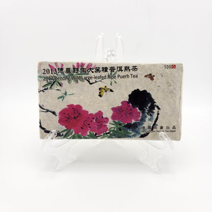 Tea packaging with floral design and text on a white background