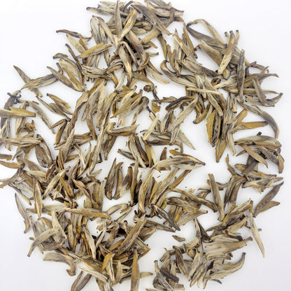 Dry tea leaves on a white background