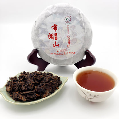 Tea cake, tea leaves, and a cup of tea on a white background