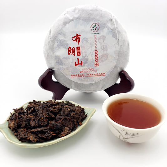Tea cake, tea leaves, and a cup of tea on a white background