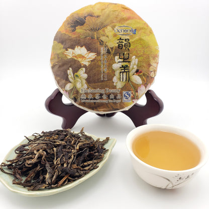 Pu-erh tea cake, brewed tea, and tea leaves on a white background