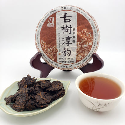 Tea packaging with a cup of tea and tea leaves on a white background