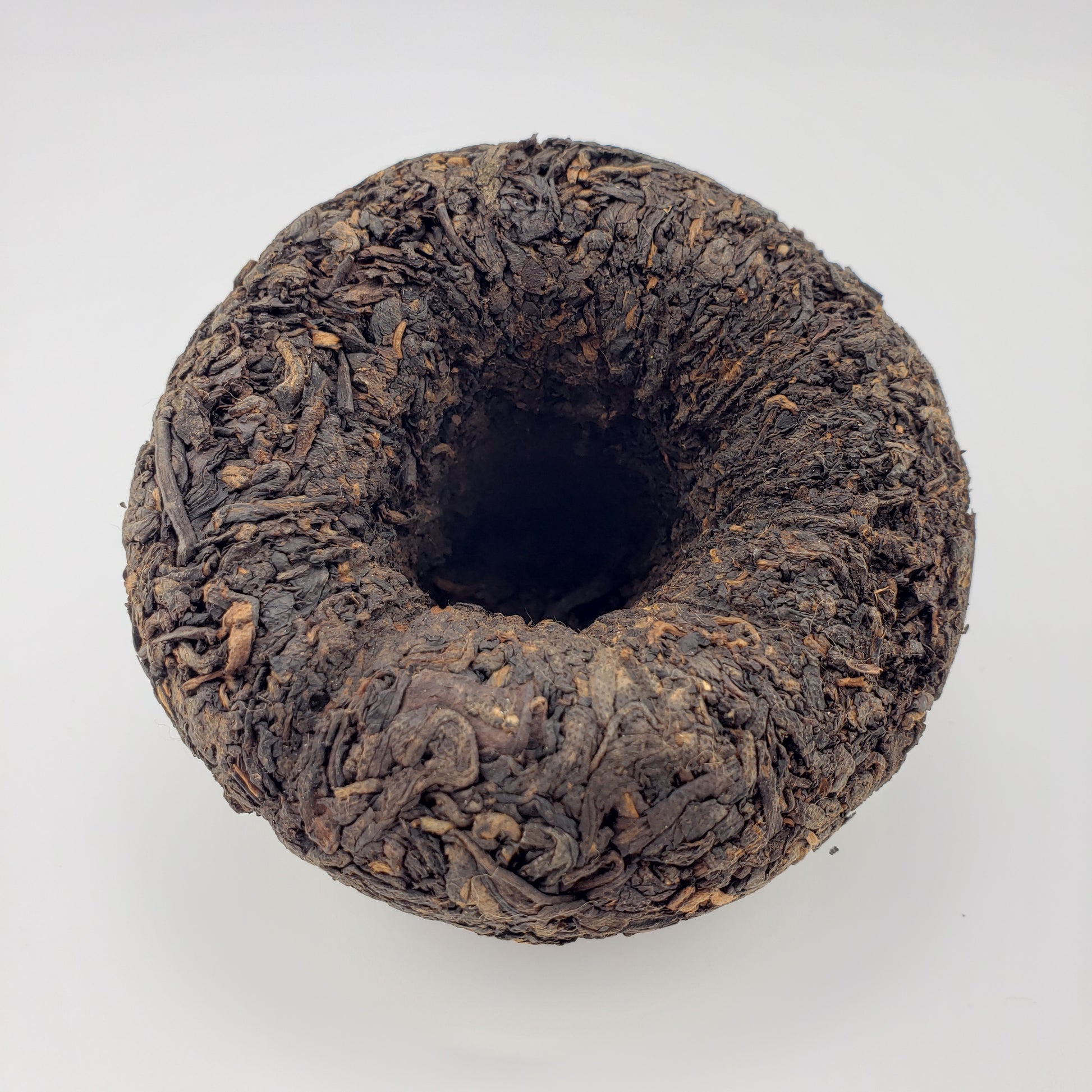 Dark brown tea cake on a white background