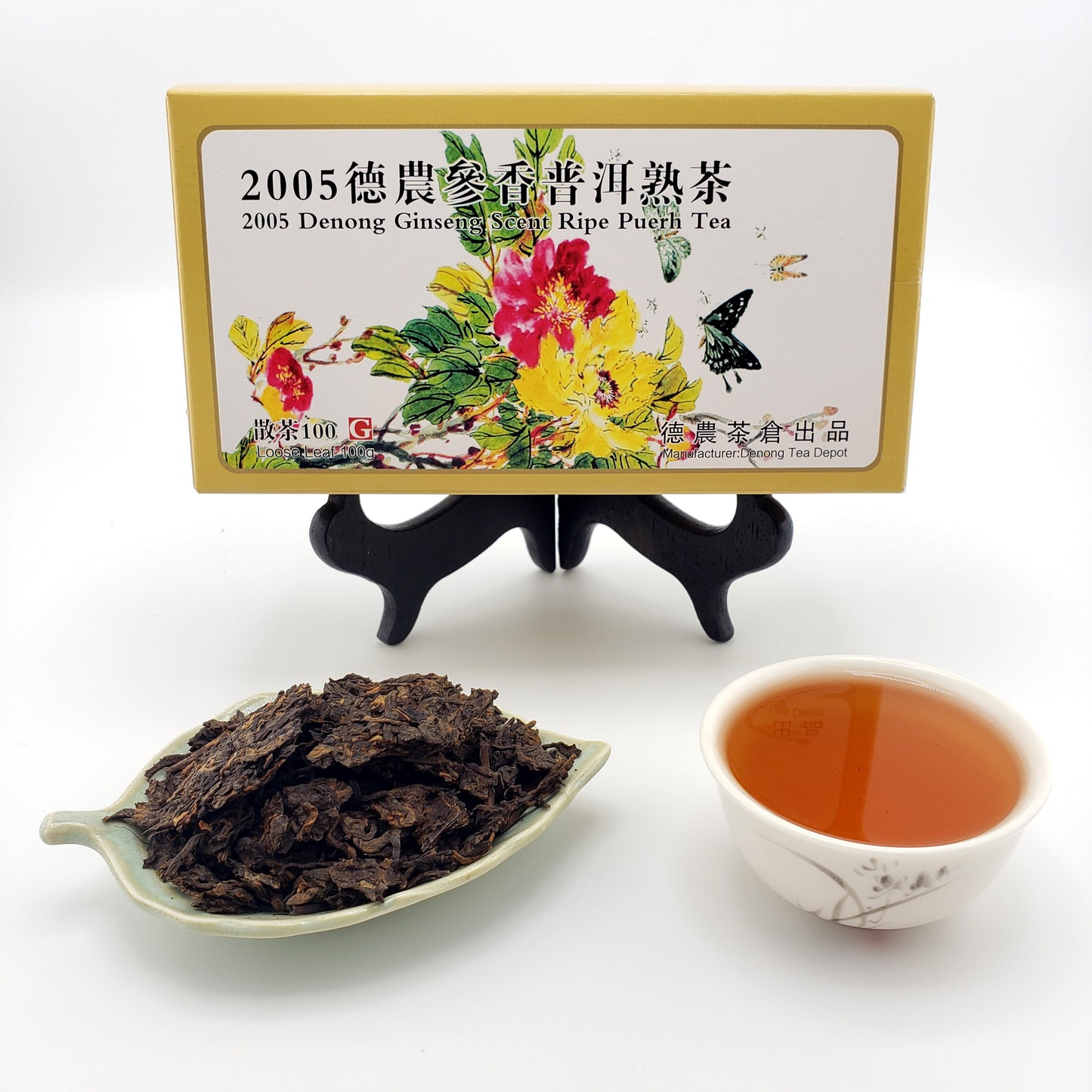 Tea packaging with tea leaves and a cup of tea on a white background