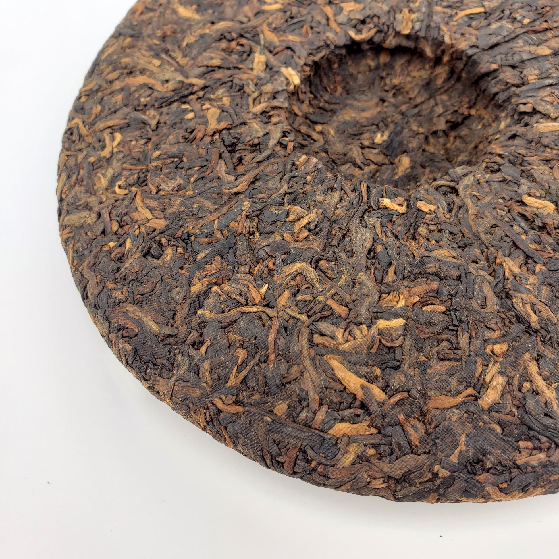 Close-up of a compressed tea cake with a white background