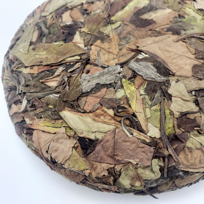 Tea cake with mixed leaf tea on a white background