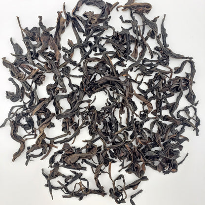 Dry oolong tea leaves on a white background