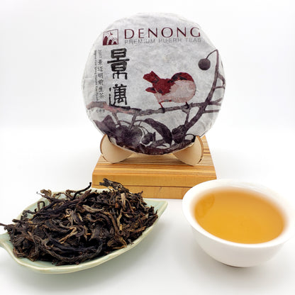 Tea packaging with a squirrel illustration, a cup of tea, and a bowl of loose tea leaves on a white background.