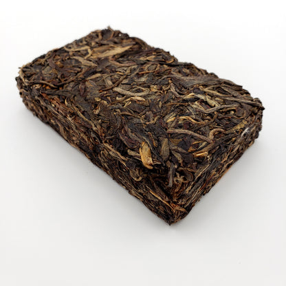 Pressed Pu-erh tea brick on a white background