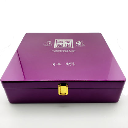 Purple jewel-toned box with gold clasp on a white background