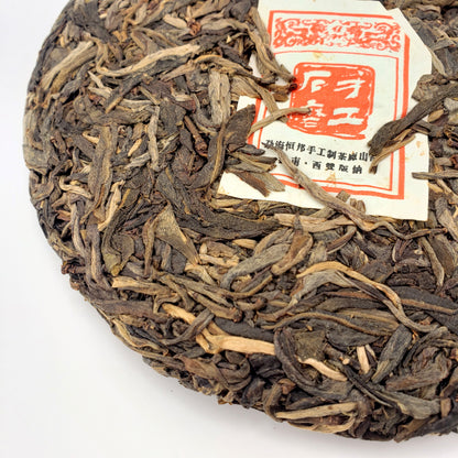 Compressed tea cake with a label on a white background