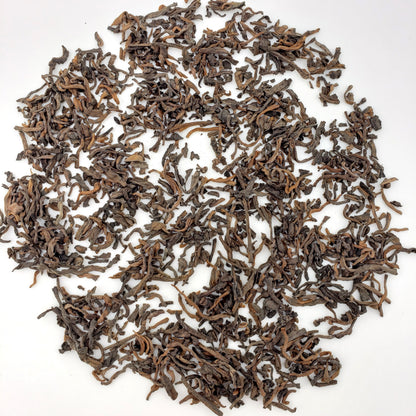 Dry tea leaves on a white background