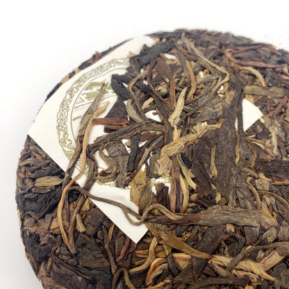 Close-up of a raw Pu-erh tea cake with nei fei paper label showing