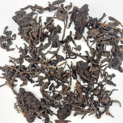 Dry tea leaves on a white background