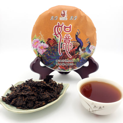 Tea packaging, cup of tea, and tea leaves on a white background