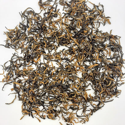 Dry black tea leaves on a white background