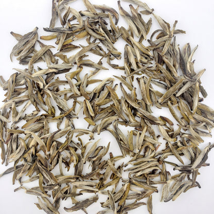 Dry tea leaves on a white background