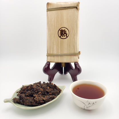 Tea packaging with a tea scoop and cup on a white background